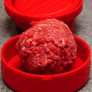 Place a round ball of ground meat on the StufZ bottom