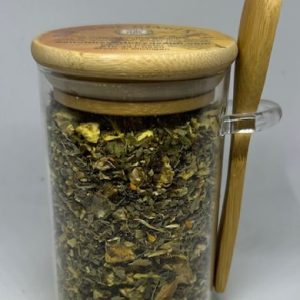 Organic Turmeric Ginger Tea in jar with wooden spoon